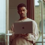 a man holding a laptop computer in his hands