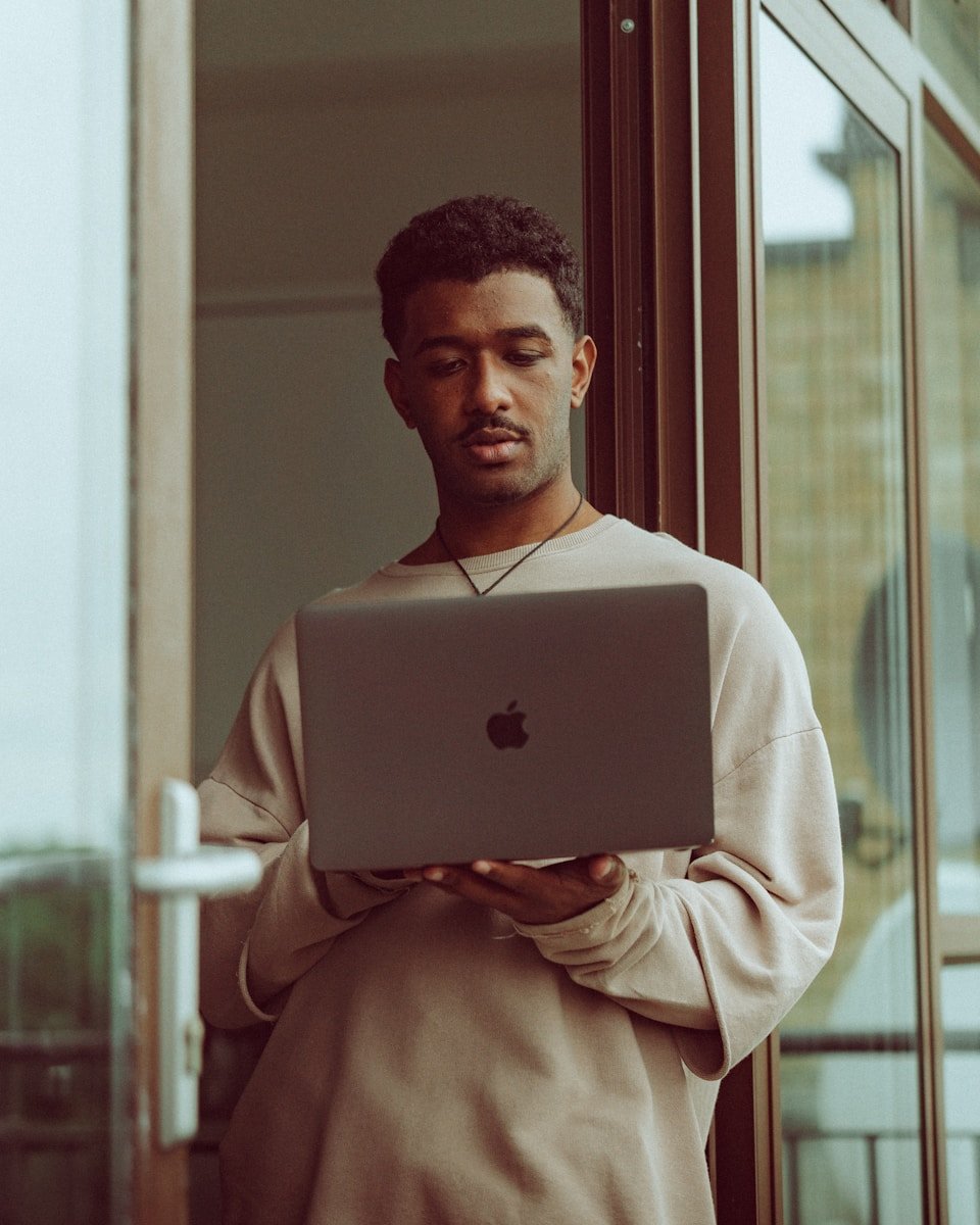 a man holding a laptop computer in his hands